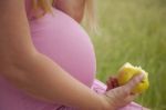 Pregnant Woman Holding Apple Stock Photo