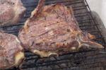 Grilling Steak On The Barbecue Stock Photo