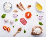 The Ingredients For Homemade Pizza On White Wooden Background Stock Photo