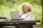 Business Lady Using Laptop In Park Stock Photo