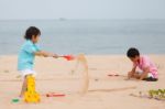 Young Brothers Play On Beach Stock Photo