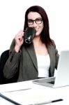 Corporate Woman Enjoying Coffee At Work Desk Stock Photo