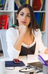 Pretty Young Woman Working With Laptop In Her Office Stock Photo