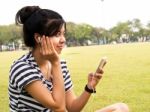 A Young Girl With Headphones Outdoors. Listening Music Stock Photo