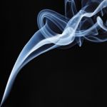 Incense Stick Smoke Trail Against A Black Background Stock Photo