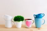 Mug And Cup Stack On Kitchen Table Stock Photo