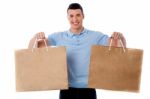 Young Man Holding Shopping Bags Stock Photo