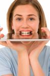 Teenage Girl Biting Tablet Pc Stock Photo