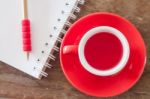 Red Mug With Open Notebook Stock Photo