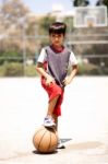 Smart Kid Holding Basketball Under His Leg Stock Photo