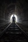 Man In A Tunnel Looking Towards The Light Stock Photo