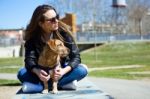 Beautiful Young Woman With Her Dog Walking In The Park Stock Photo