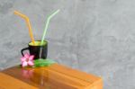 
Black Coffee Cup On The Table Brown Wood Trim With Colorful Flo Stock Photo