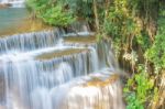 The Water Flowing Over Rocks And Trees Down A Waterfall At Huay Mae Khamin Waterfall National Park ,kanchana Buri In Thailand Stock Photo