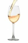 White Wine Pouring Into A Glass Isolated On White Stock Photo