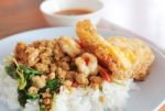 Spicy Fried Pork And Shrimp With Basil Leaves And Fried Egg Stock Photo