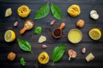 The Ingredients For Green Pesto Sauce On Dark Wooden Background Stock Photo