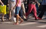 Feet Of The Pedestrians On City Street Stock Photo