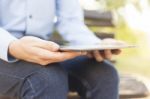 Businessman With Tablet Computer In Park Stock Photo