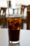 Glass Of Cola With Ice On A Table Stock Photo