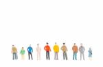 Group Of Miniature People Standing On White Background Stock Photo