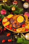 Christmas Baked Duck Served With Potatoes, Orange And Tomatoes Stock Photo