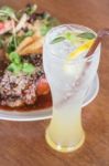 Delicious Barbecued Ribs And Lemon Soda Drink Stock Photo