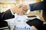 Businessmen Shaking Hands During A Meeting Stock Photo