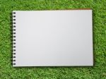 Note Book On Green Grass Stock Photo