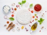 The Ingredients For Homemade Pizza On White Wooden Background Stock Photo