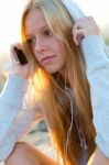 Beautiful Girl Sitting On The Roof And Listening To Music Stock Photo