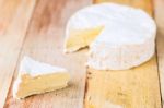 Camembert Cheese With Cut Wedge And Vintage Knife On Wooden Tabl Stock Photo