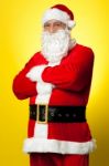 Confident Male Santa Posing With Arms Folded Stock Photo