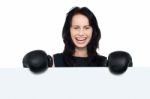 Woman With Boxing Gloves On Posing Behind Billboard Stock Photo