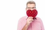 Handsome Man Holding Heart Shape Gift Box Stock Photo