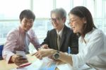 Group Of Business People Meeting With Happiness Emtion Pointing To Smart Phone In Hand Use For Modern Working People Lifestyle On Digital Technology Stock Photo