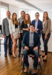 Portrait Of Business Team With Wheelchair Stock Photo