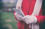 Woman In Wool Gloves Hold Smart-phone Stock Photo