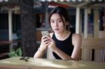 Portrait Of Thai Adult Student University Beautiful Girl Using Her Smart Phone Stock Photo