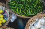 Baskets Full Of Peppers, Garlic, And Lemons Stock Photo