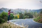 Tourist Hitchhiking Woman Standing On The Road In The Mountains Stock Photo