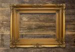 Old Brown Picture Frame On Wooden Background Stock Photo