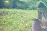 Beautiful Woman With Tablet Computer In Park Stock Photo