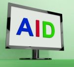 Aid On Monitor Shows Aiding Help Or Relief Stock Photo