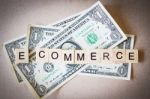 Wooden Block Word E-commerce And Dollar Banknote Stock Photo