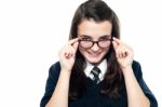 Schoolgirl Adjusting Her Spectacles Stock Photo