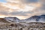 Snowy Icelandic Mountains With Dramatic Cloudy Sky Stock Photo