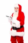 Santa Surfing Wen On Tablet Stock Photo