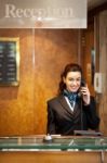 Woman Receptionist Talking Phone Stock Photo