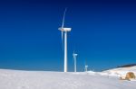 Wind Turbine And Blue Sky In Winter Landscape Stock Photo